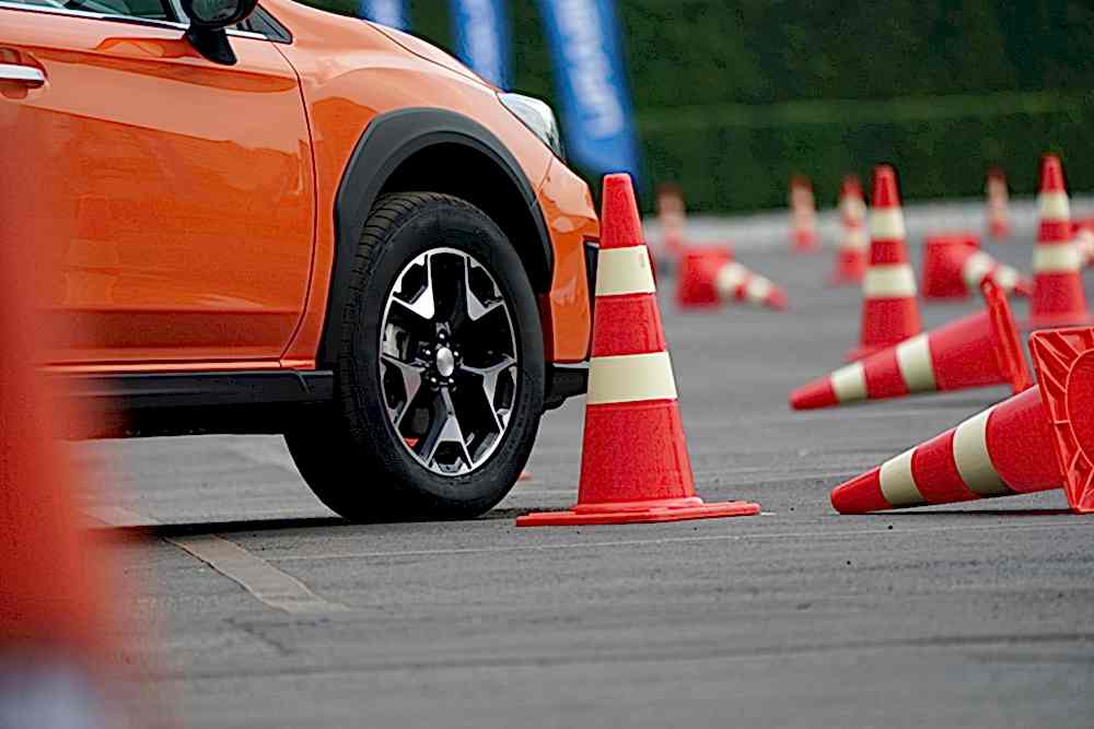 close up wheel of orange car on the road